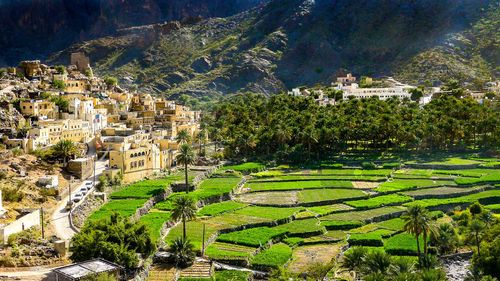 The beautiful mountain village of Balad Sayt sits in front of green fields in Wadi Bani Awf, Oman © Kylie Nicholson/Shutterstock