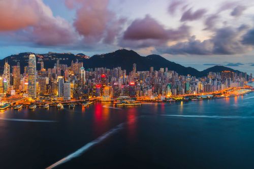 hong-kong-island-victoria-harbour-sunset-shutterstock_1180711618