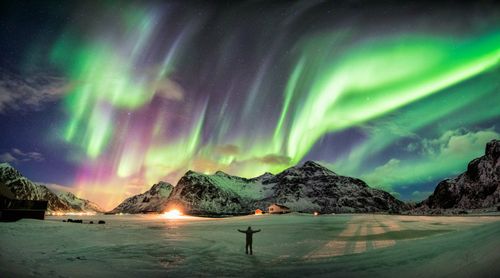 northern-lights-skagsanden-beach-lofoten-norway-shutterstock_1120772963