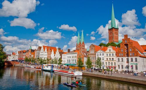 St. Marien and St. Petri cathedral towers with the Hansahafen River in the foreground, Lubeck, Germany